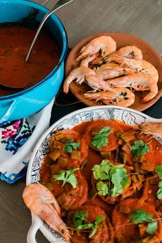 there are many different types of food on the table, including shrimp and tomato sauce