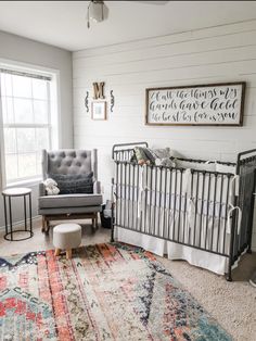 a baby's room with a crib, rocking chair and large rug on the floor