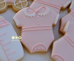 decorated cookies in the shape of baby's boot and diaper on a table