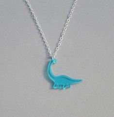 Dinosaur Necklaces The dinosaur pendants are made of translucent acrylic. The pendants hang on a 1.5 x 2 mm silver plated cable chain, with a lobster clasp closure. The blue Brontosaurus measures 1" x 1". The green Tyrannosaurus Rex measures 1" x 3/4". The pink Pterodactyl measures 1/2" x 1". Choose your dinosaur and length from the drop-down lists. If you need more than what is listed, please contact me regarding availability. Dinosaur Necklaces, Dinosaur Pendant, Dinosaur Necklace, Tyrannosaurus Rex, Cable Chain, The Pink, Lobster Clasp, Charm Necklace, Silver Plate