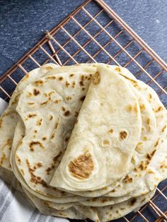 four tortillas sitting on top of a cooling rack