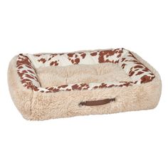 a brown and white dog bed with spots on it