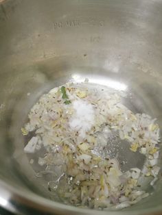 a metal bowl filled with rice and seasoning