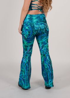 Be the raddest kitty at the festival in our most requested pants, the Groovy Bellbottoms! Made for booty-shaking, featuring a wide slimming waistband. Perfect flare while hugging every curve. Product Details 4-way stretch spandex blend Wide self stretch waistband Handmade in Brooklyn All items are made to order. Need a customization? Reach out to us HERE so we can provide you the perfect fit. Trendy High Waist Pants For Festival, Trendy High Waist Bottoms For Festivals, Trendy Stretch Pants For Festivals, Trendy Blue Festival Pants, Trendy Blue Pants For Festival, High-waisted Pants For Festival, Blue Bottoms For Fall Festival, Trendy Fitted Blue Flares, Trendy Fitted Flare Bottoms