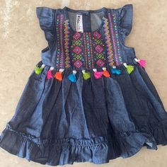 Kids Headquarters Toddler Girls Denim Embroidered Dress. Size 24m. New Without Tags, Never Worn. 100% Cotton. Fun, Flowy Denim Dress With Bright Colorful Embroidery On Chest, Tassels, Ruffle Cap Sleeves And Hem And 3-Button Closure At Back. Stylish And Easy To Wear. Kids Denim Dress, Dressy Clothes, Frocks For Kids, Dec 1st, Casual Frocks, Kids Blouse Designs, Kids Blouse, Kids Dress Wear