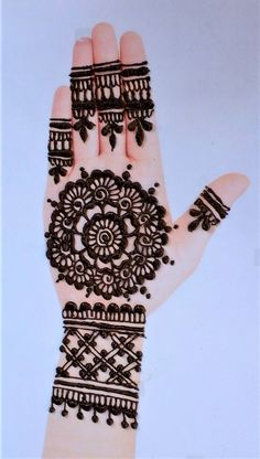 a woman's hand with henna on it