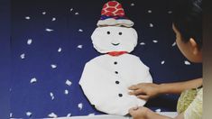 a person making a snowman out of toilet paper