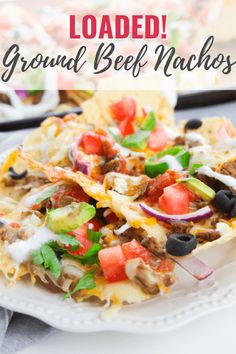 loaded ground beef nachos on a white plate with text overlay that reads loaded ground beef nachos