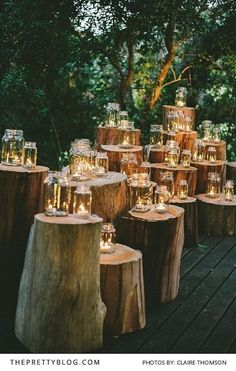 many candles are lit on wooden logs