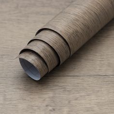 a close up of a wooden floor with a roll of wood covering it's surface