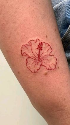 a person with a tattoo on their arm has a flower in the middle of his arm