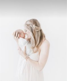 a woman holding a baby in her arms