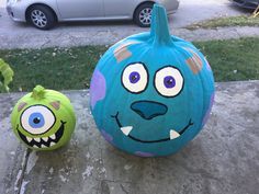 two pumpkins painted to look like monsters