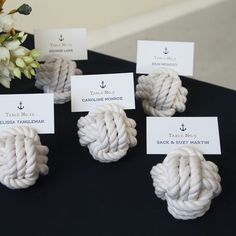 there are four knots on the table with place cards