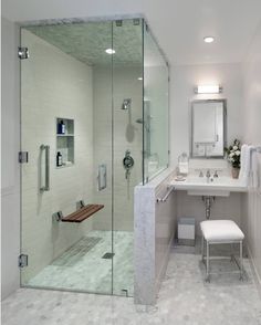 a bathroom with a walk in shower next to a sink