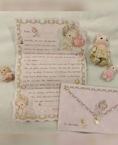 two teddy bears are sitting next to a baby's birth certificate and other items