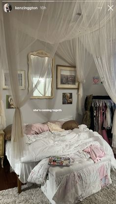 a white bed sitting in a bedroom next to a window