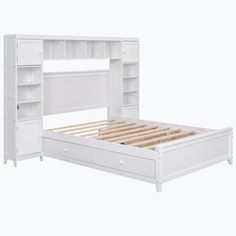 a white bed with drawers underneath it and a book shelf above the headboard,