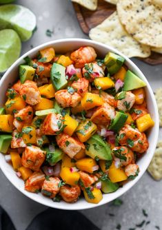 a white bowl filled with shrimp and mango salsa