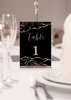 a table setting with place cards and wine glasses