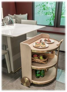 a small table with food and drinks on it in front of a kitchen counter top