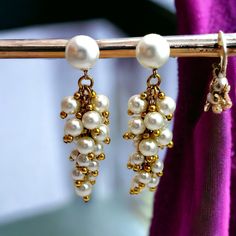 1960's Faux pearl and gold drop earrings. Clip on. Marked 'Made in Western Germany' Material: Plastic & metal Colour: Pearl & gold Size: Length - 9.5cm (3.74 inches). Width - 3cm (1.18 inches) at widest point  Weight - 6g each Condition: Excellent vintage condition. All beads intact. Clips in good condition Very minimal wear.  Please note.. I do my best to represent each item and its condition as accurately as possible but vintage items are in pre loved condition and will show signs of general a Gold Pearl Earrings With Dangling Beads For Party, Lustre Vintage, Vintage Chandelier, Gold Drop Earrings, Pearl Drop, Chandelier Earrings, Vintage Earrings, Clip On, Faux Pearl