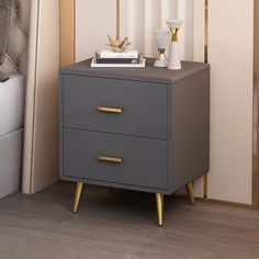 a nightstand with two drawers next to a bed