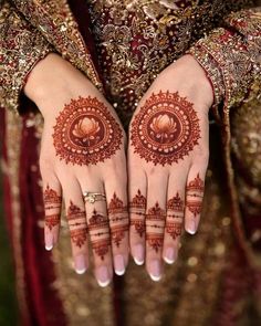 a woman's hands decorated with hennap