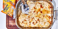 a casserole dish with cheese and crackers next to it