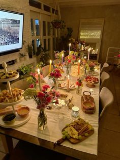 a table is set up with food and candles