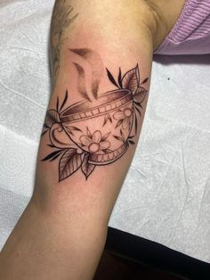 a tattoo on the arm of a person with a clock and flowers in it's basket