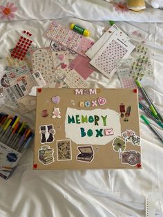 a memory box surrounded by crafting supplies on a sheet of white paper with the words memory box written in it