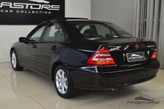 a black car is parked in a showroom