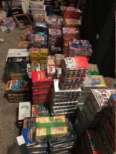 a pile of nintendo games sitting on top of a floor