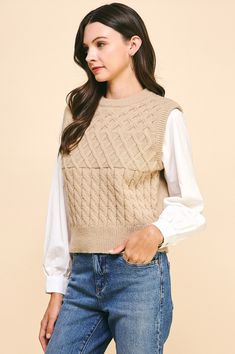 a woman is wearing a sweater and jeans