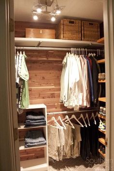 an organized closet with clothes and baskets