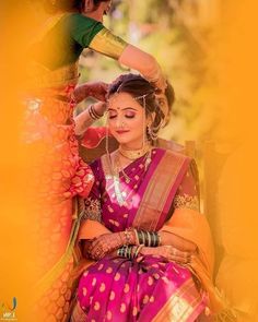 a woman in a pink and yellow sari with her hands on her head, looking at the camera