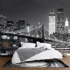 a bedroom with a city skyline wallpaper and a bed in front of the brooklyn bridge