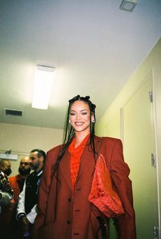 a woman with dreadlocks standing in a hallway