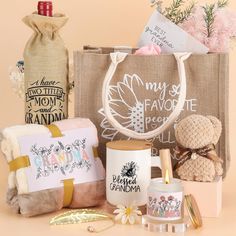 the contents of a gift bag are displayed on a beige surface with flowers and other items