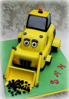 a cake made to look like a construction vehicle with eyes on it's face