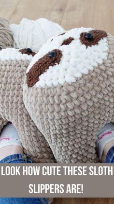 there are two stuffed sheeps on the floor with text overlay that reads, look how cute these sloth slippers are