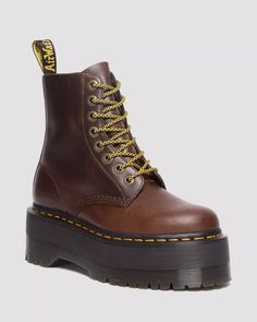 Created to be worn at full capacity, this outstanding revision of the classic 8-eye configuration is complemented with our highest Quad Max sole. The upper is constructed from the strong, supple Classic Pull Up leather, which will become more unique with time. Accompanied with antique gold eyelets and either black or giraffe laces, the design is finalized with signature Dr. Martens touches such as a black and yellow heel loop and yellow welt stitching. Born on 01.04.60. Named the 1460 boot. Over Brown Dr Martens, Platform Doc Martens, Leather Platform Boots, Black Platform Shoes, Yellow Heels, Fur Accessories, Boots Uk, Tripp Nyc, Black Platform