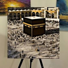 a painting of the ka'bah in front of some paintings on easels