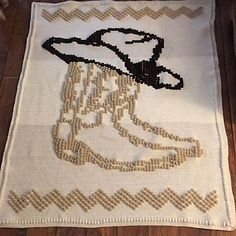 a knitted rug with an image of a boot on it