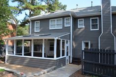 a gray house with white trim and windows