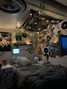 a bed room with a neatly made bed and lots of plants hanging from the ceiling