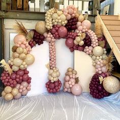 a large number made out of balloons and other items on a table with some stairs in the background