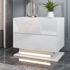 a white cabinet with a plant on top