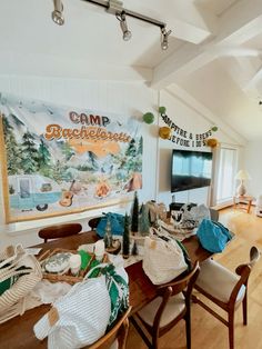 a living room filled with furniture and a flat screen tv sitting on top of a wooden table